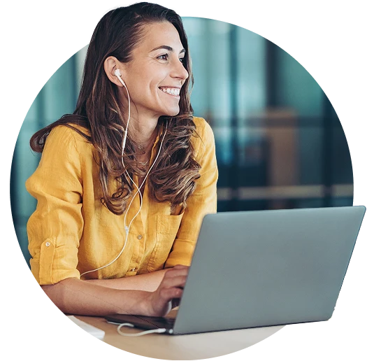 Professional woman using a laptop and headset during a virtual meeting
